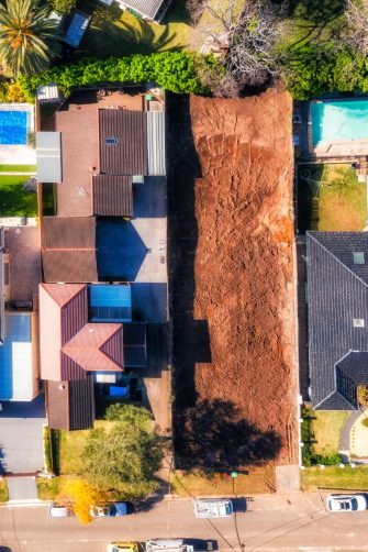 Demolished home building construction site in residential suburb of City of Ryde in Sydney West - aerial top down view.