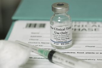 Clinical trial medicine, for the covid-19 coronavirus, on clipboard