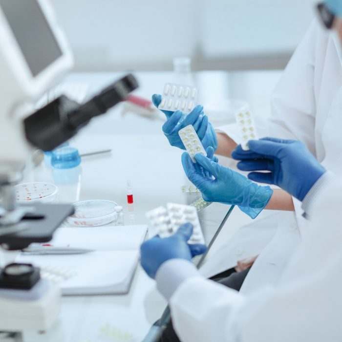 Pharmacists discussing a new drug in the laboratory .