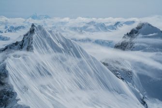 Snow-covered mountain peaks in the fog