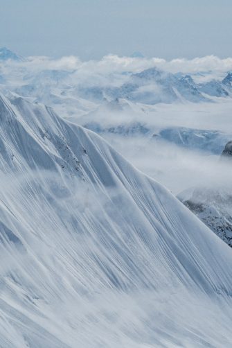 Snow-covered mountain peaks in the fog