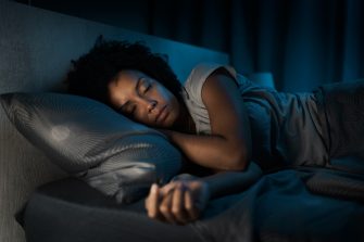 Woman sleeping in her bed at night