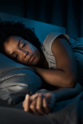 Woman sleeping in her bed at night