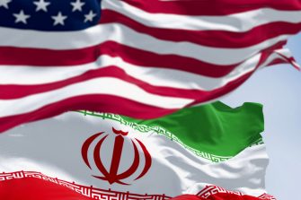 USA and Iran flags waving together