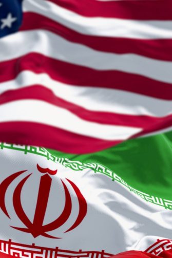 USA and Iran flags waving together