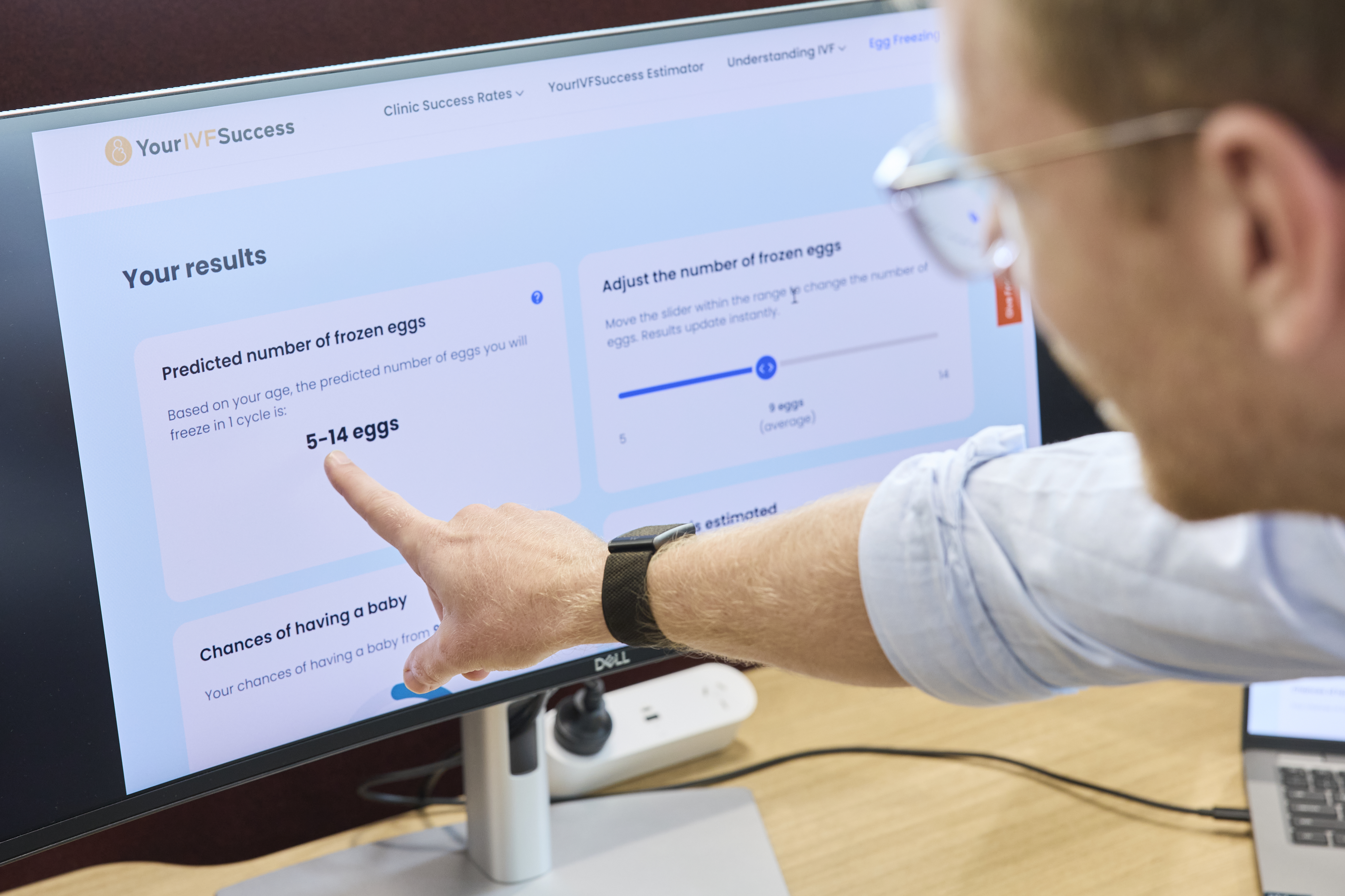 A man pointing to a computer screen.