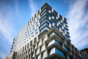the exterior of the Health Translation Hub towers in a sunny sky