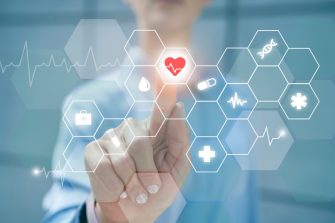 Businesswoman touching heart shape on digital display