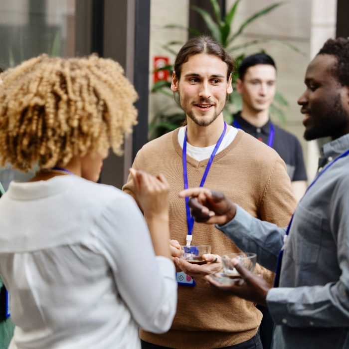 Group of people chatting during networking break at business conference