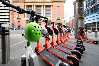 Melbourne, Australia - November 20, 2022: Shared e-scooters parked on the roadside in the city
