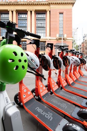Melbourne, Australia - November 20, 2022: Shared e-scooters parked on the roadside in the city