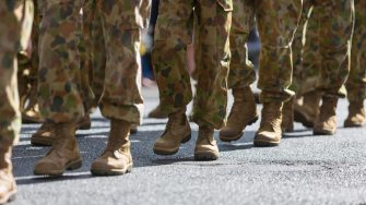 Close-up of the legs and boots of Australian soldiers marching