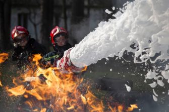 Firefighters using firefighting foam to fight a fire