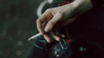 hand holding cigarette stock 