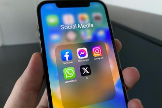 Social media app icons on a mobile phone screen stock