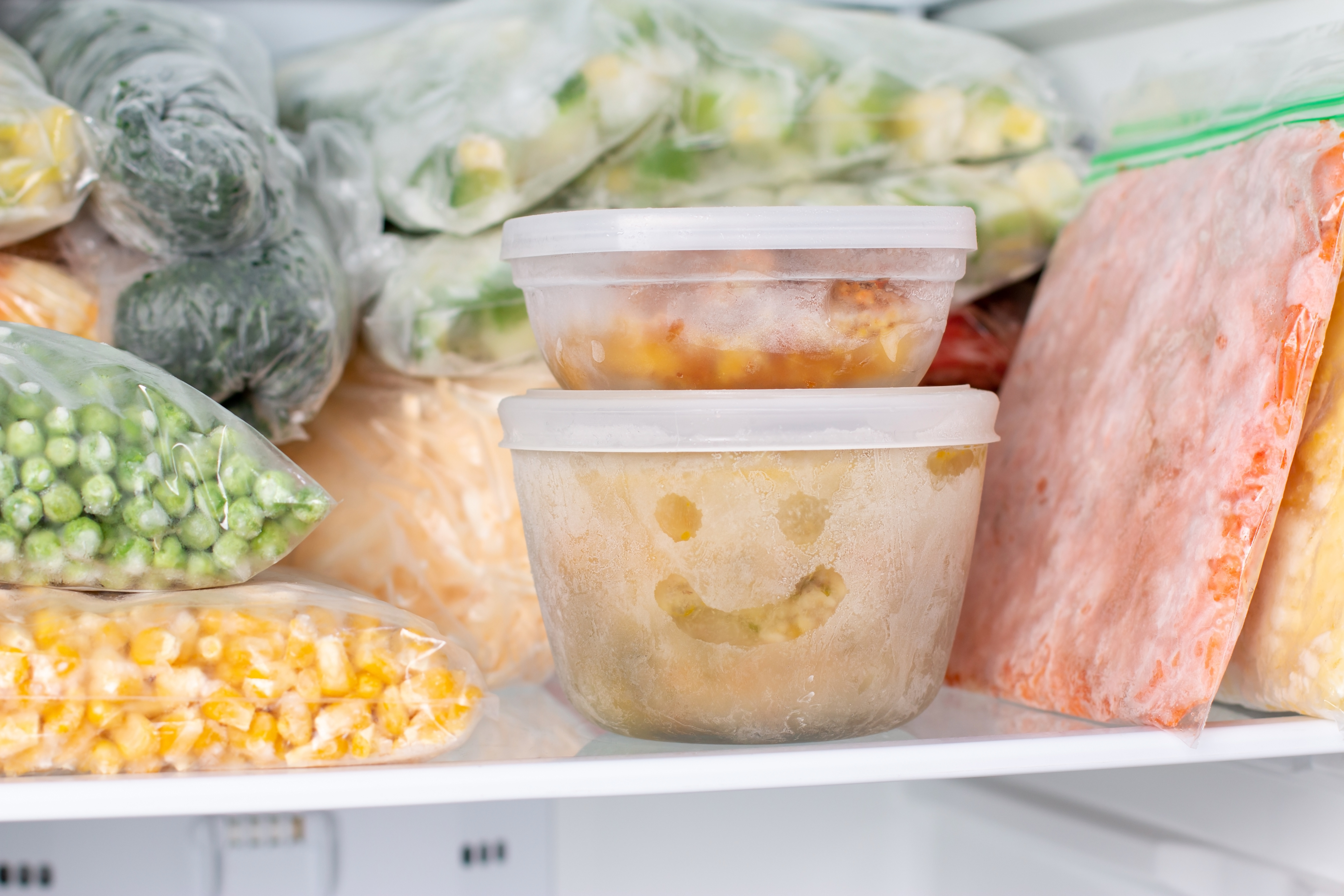 Frozen food in the freezer. Frozen vegetables, soup, ready meals in the freezer