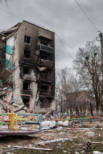 Mother and her daughter in destroyed building.