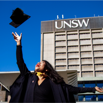 graduate at unsw throwing graduate hat in the air