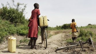 a girl holding a bike