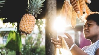 a girl holding a bag of corn and leaning