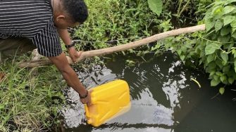 a man collecting water with a tank from water
