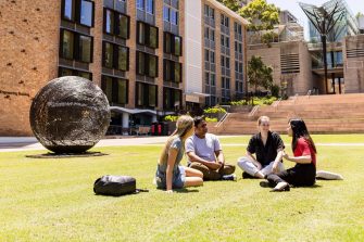 Photo of students chatting on lawn at UNSW Kensington campus
