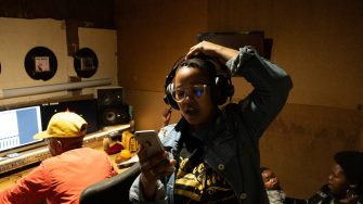 A female Hip Hop artist records in the studio during a Rebel Sistah Cypher collaboration in Khayelitsha, Cape Town.