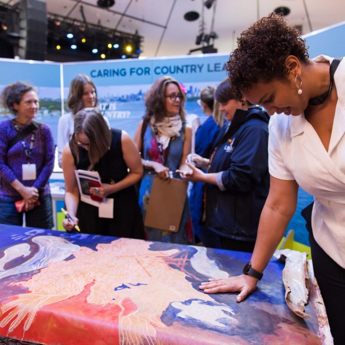 Guests at the Massive Action Sydney Unconvention interacting with the Caring For  Country Leave project team's exhibit space