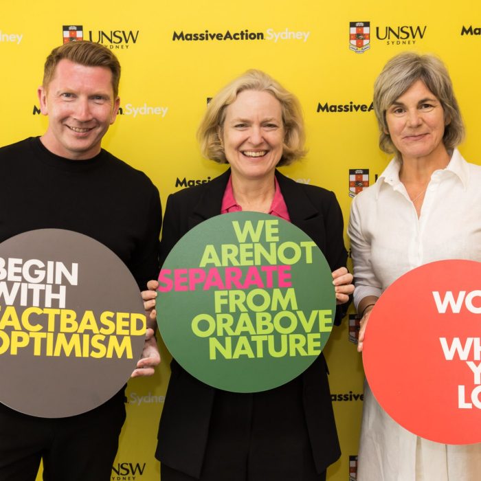 Prof Claire Annesley with Verity Firth and Kevin Finn holding up MC24 principles at the Massive Action Sydney Unconvention in March 2024 