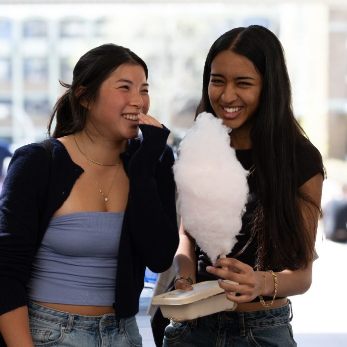 Students enjoying fairy floss at Diversity Festival