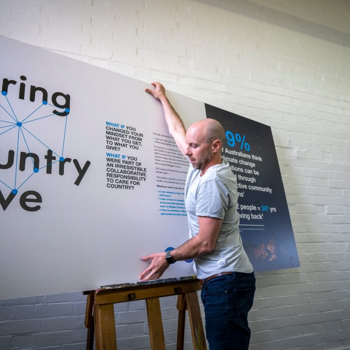 Person placing display board on easel exhibition 