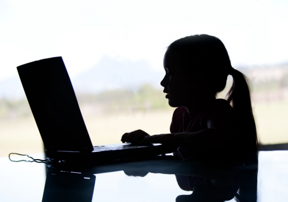 Child sitting at laptop