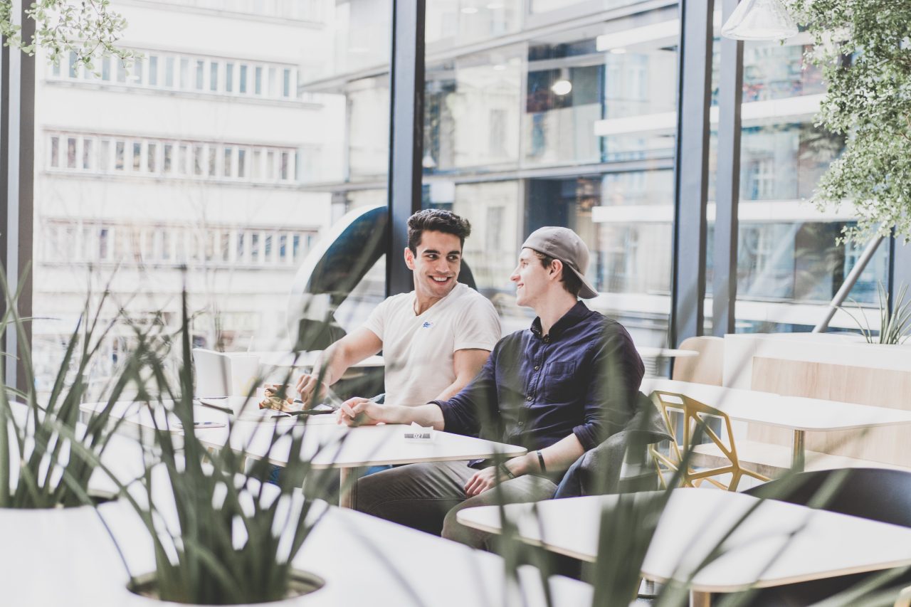 Two people at a table chatting and smiling