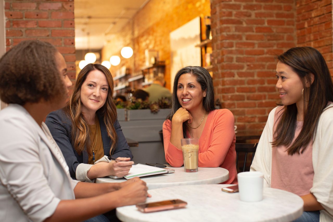 Four women in a business meeting at a cafe