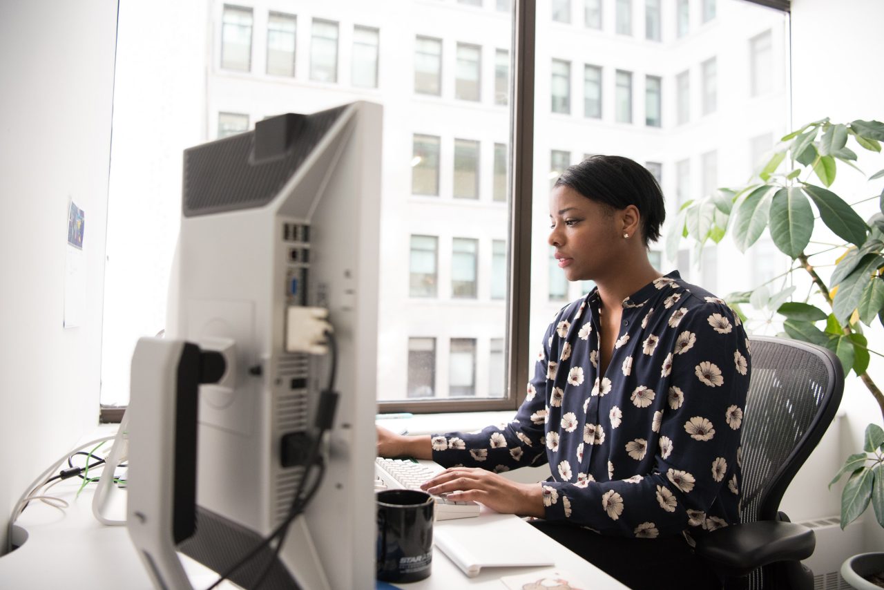 Woman in office looking at a computer screen
