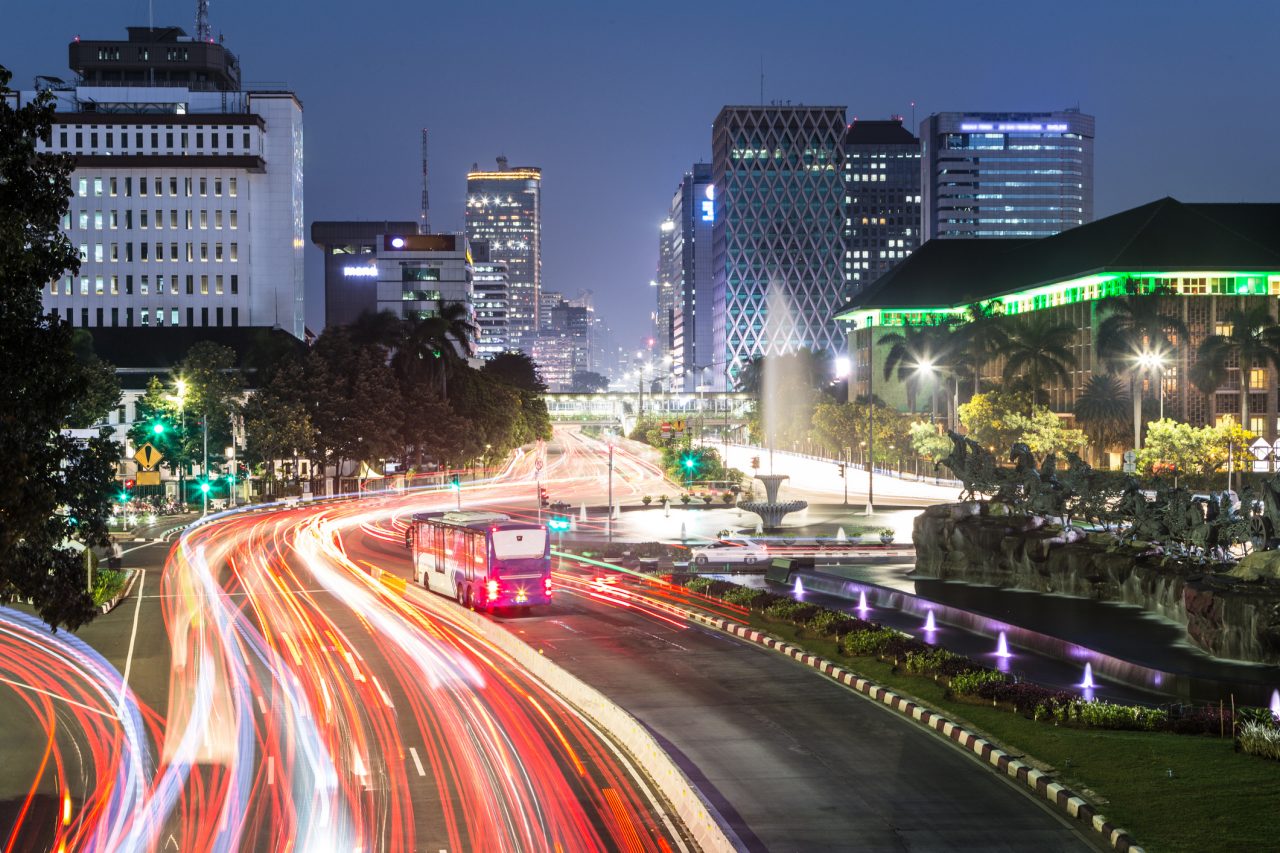 Traffic light trails along Jakarta main avenue in the business district at night in Indonesia capital city. The Transjakarta bus has its own traffic line to avoid the heavy congestion in the city.