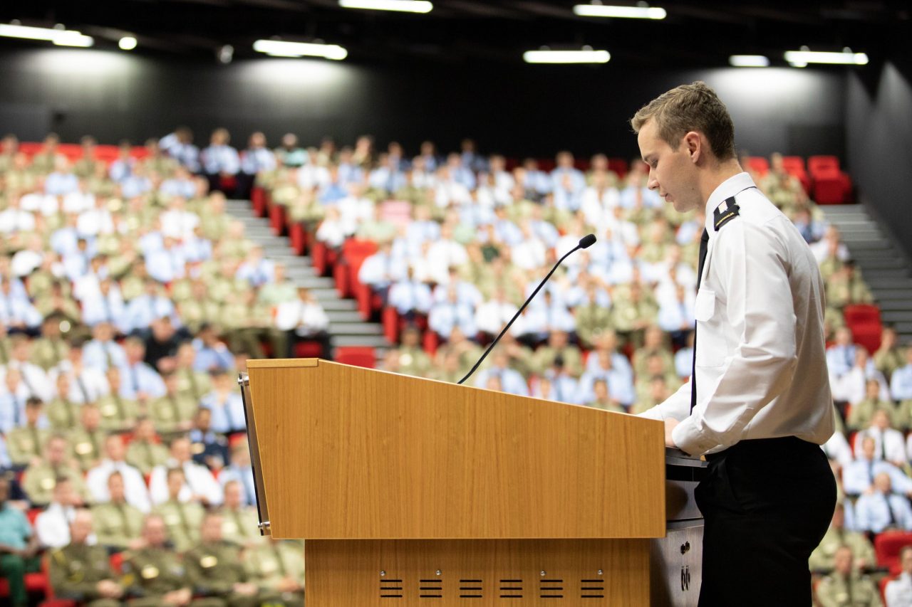 Student in military uniform presenting to audience