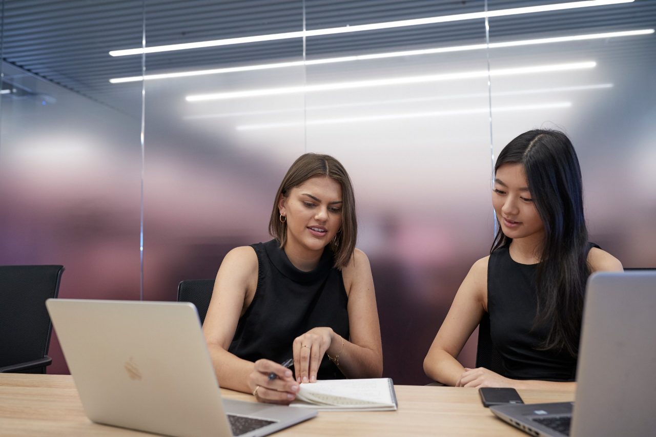 Post graduate students working on computers, talking and studying at the business school, Kensington UNSW