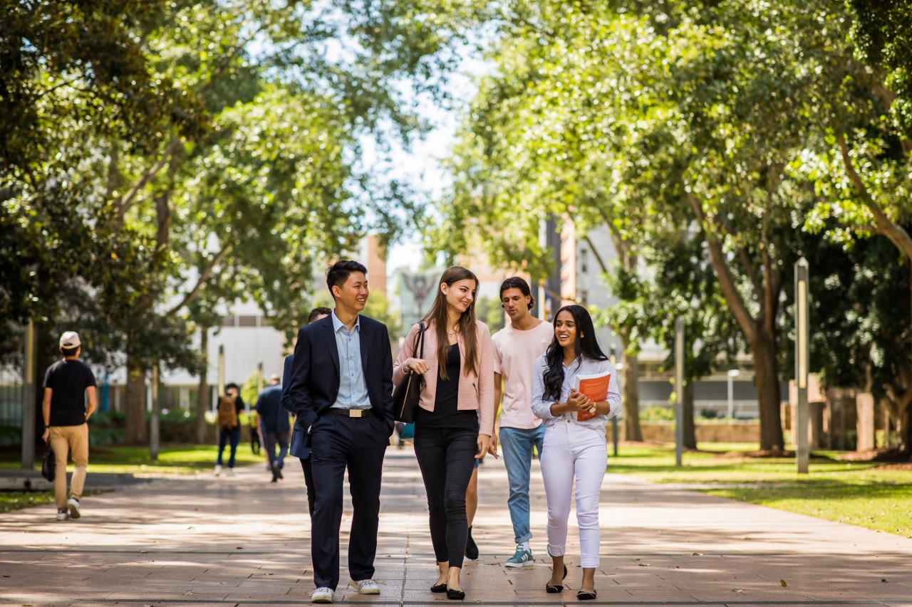 four students walking through the UNSW Kensington campus