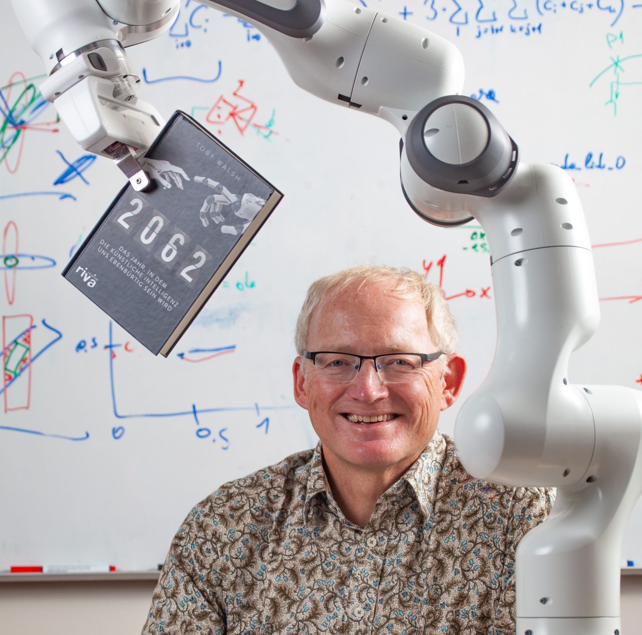 Prof. Toby Walsh with robot arm