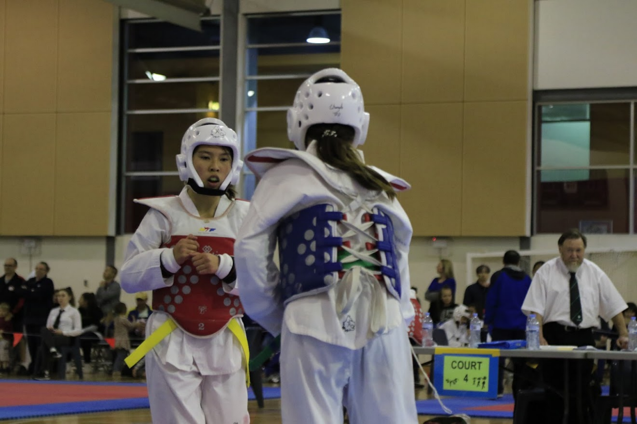 Two students competing in taekwondo