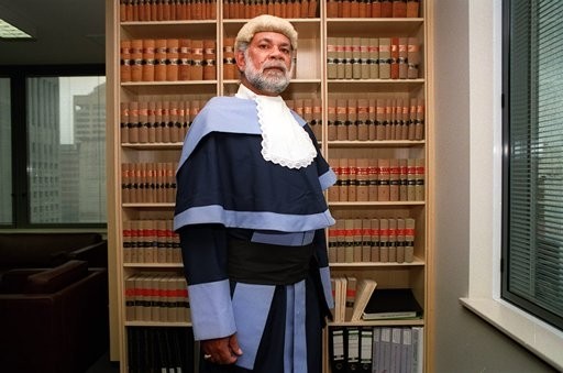 a picture of Judge Bob Bellear in front of bookshelves