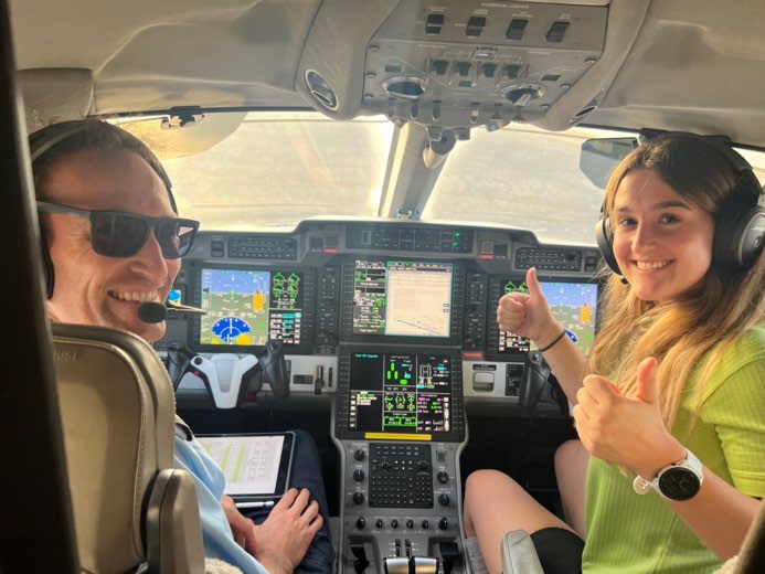 Rebecca and pilot in aeroplane cockpit