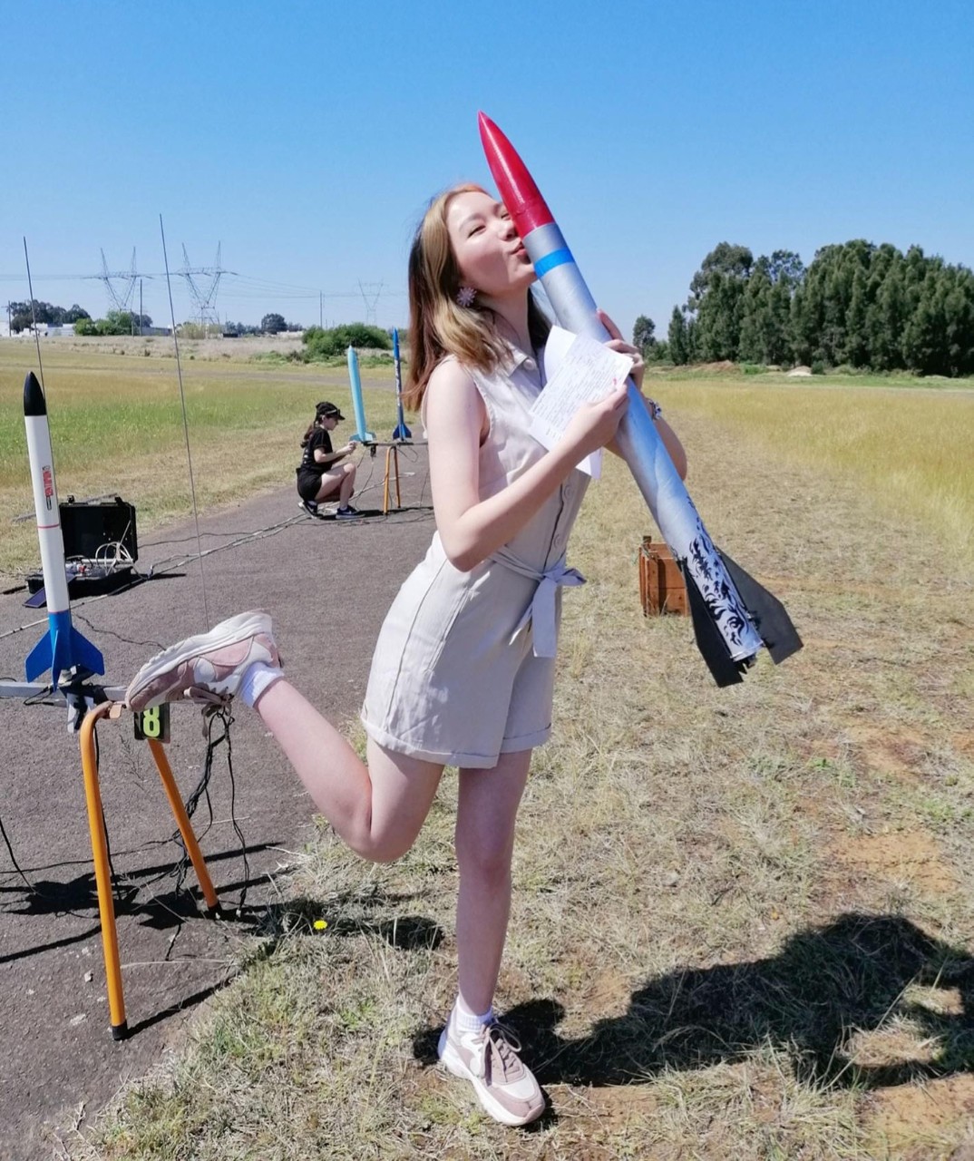 female student holding rocket