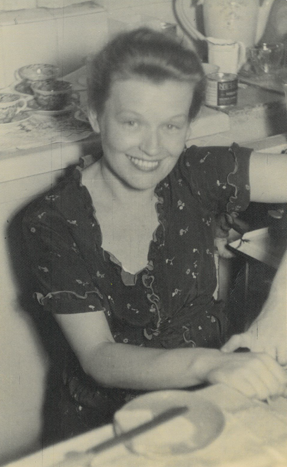 A photo of Galina Sugowdz sitting at the table and looking to the camera