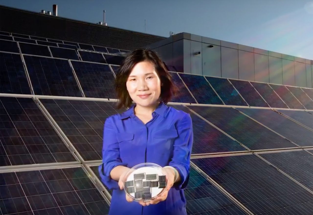 Xiaojing Hao with solar panels