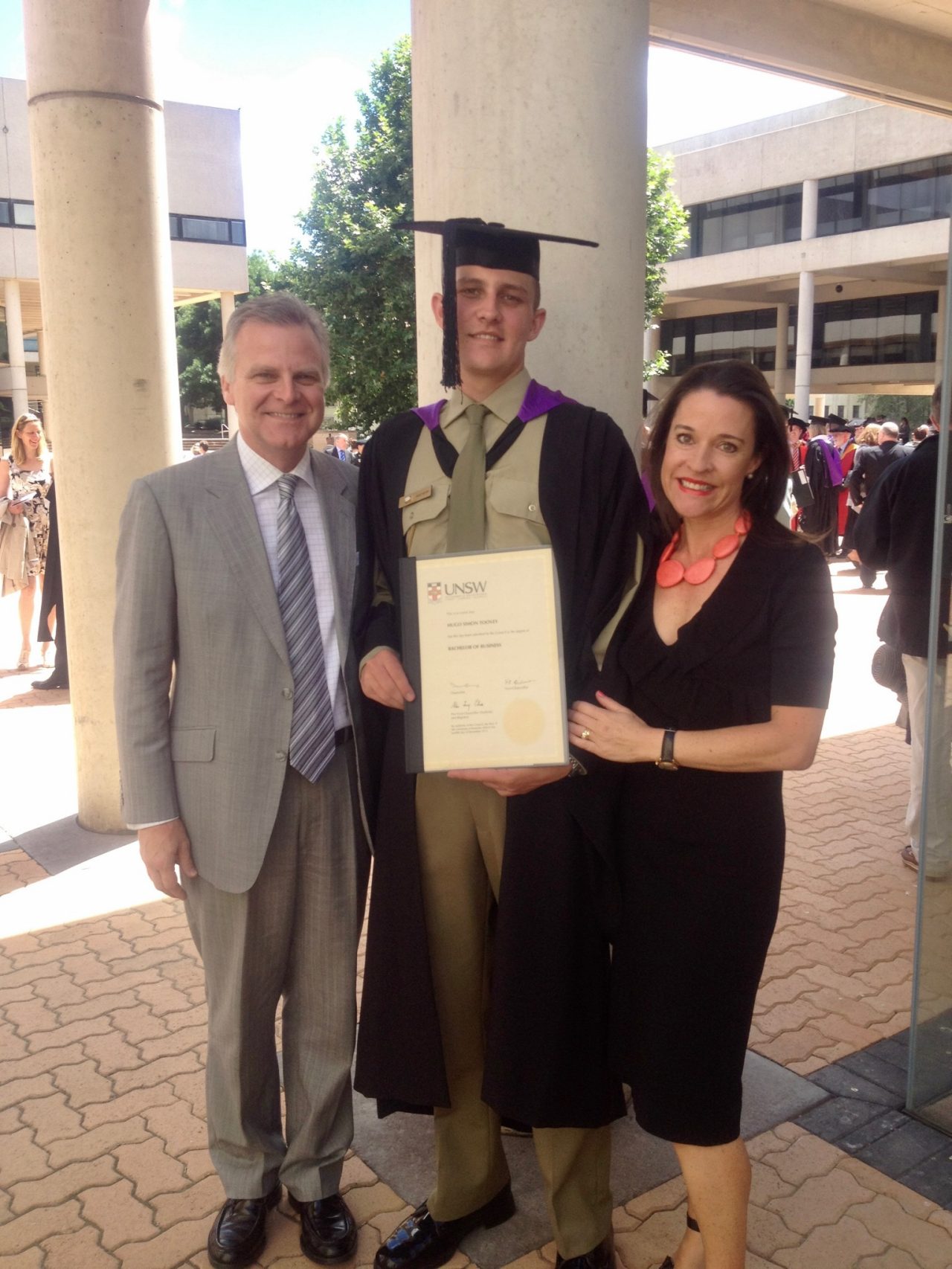 Hugo Toovey with his parents at his graduation from UNSW Canberra.