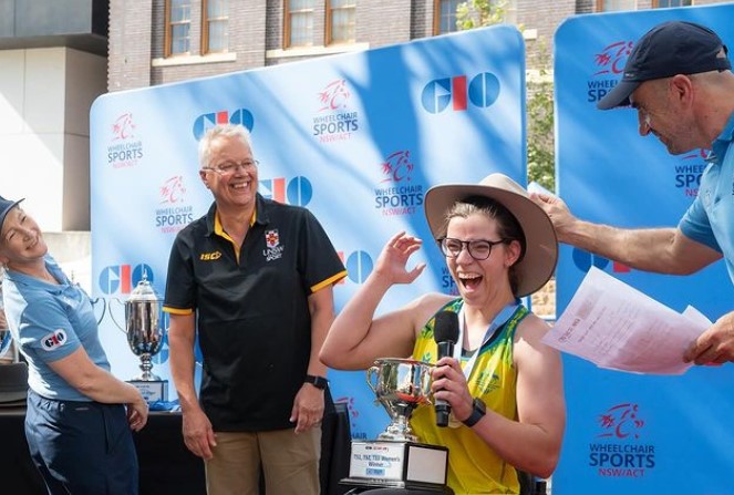 Mark Wright, Head of Sport at UNSW, presenting the awards to the winner of the T51,52,33 category, Sarah Clifton-Bligh.