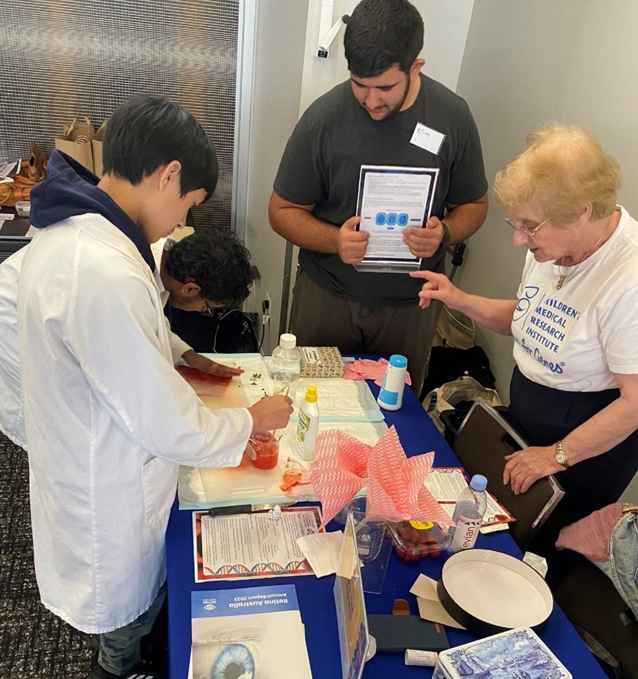 Children’s Medical Research Institute booth at lunchtime, extracting DNA from strawberries with several of our attendees 