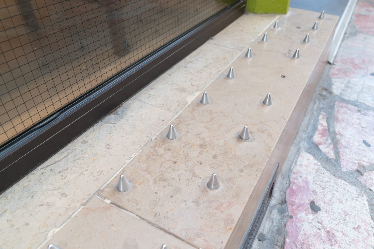 Anti-homeless spikes defensively designed street furniture